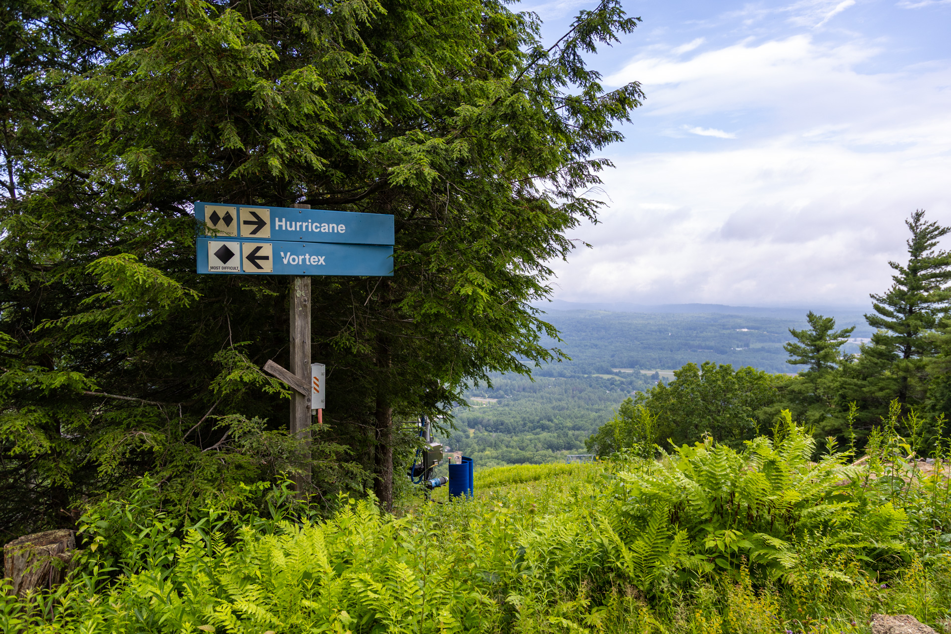 John Deere 748H Grapple Skidder by Fall Line Construction clearing brush and moving pipe segments up ski slopes at Pats Peak Ski Area during snowmaking upgrades.